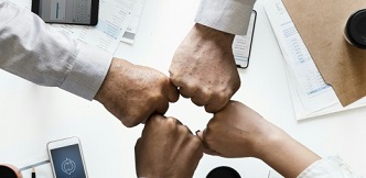 Puños de trabajadores juntos, qué produce enfermedades infecciosas y parasitarias