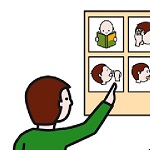 Niño señalando con la mano eeeeen un tablero de pictogramas.