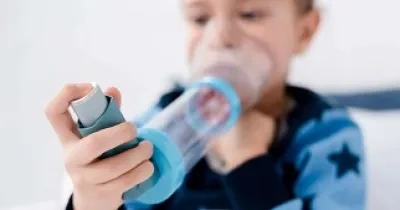 Un niño que sufre asma, inhalando su tratamiento (Fuente: SEICAP)