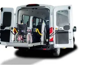 parte trasera abierta de una furgoneta subiendo en la rampa a una silla de ruedas