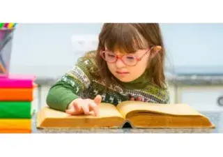 Niña con síndrome de Down leyendo